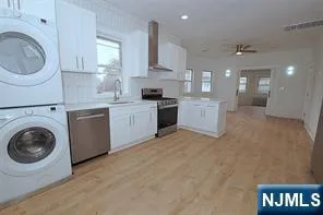a large kitchen with a cabinets and stainless steel appliances