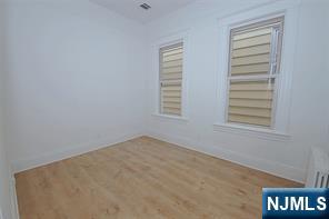 63 Van Winkle Avenue, Unit 2 Garfield, NJ 07026 - Photo 4 of 15 a view of an empty room with a window