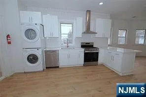 a kitchen with cabinets a washer and dryer