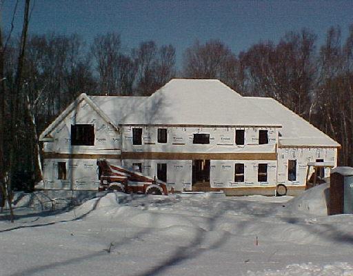 99 Winter Ridge Road Newtown, CT 06482 - Photo 1 of 1 a view of a white house with a yard and wooden fence