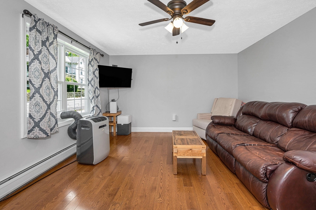 43 West Main Street Orange, MA 01364 - Photo 11 of 32 a living room with furniture and a flat screen tv