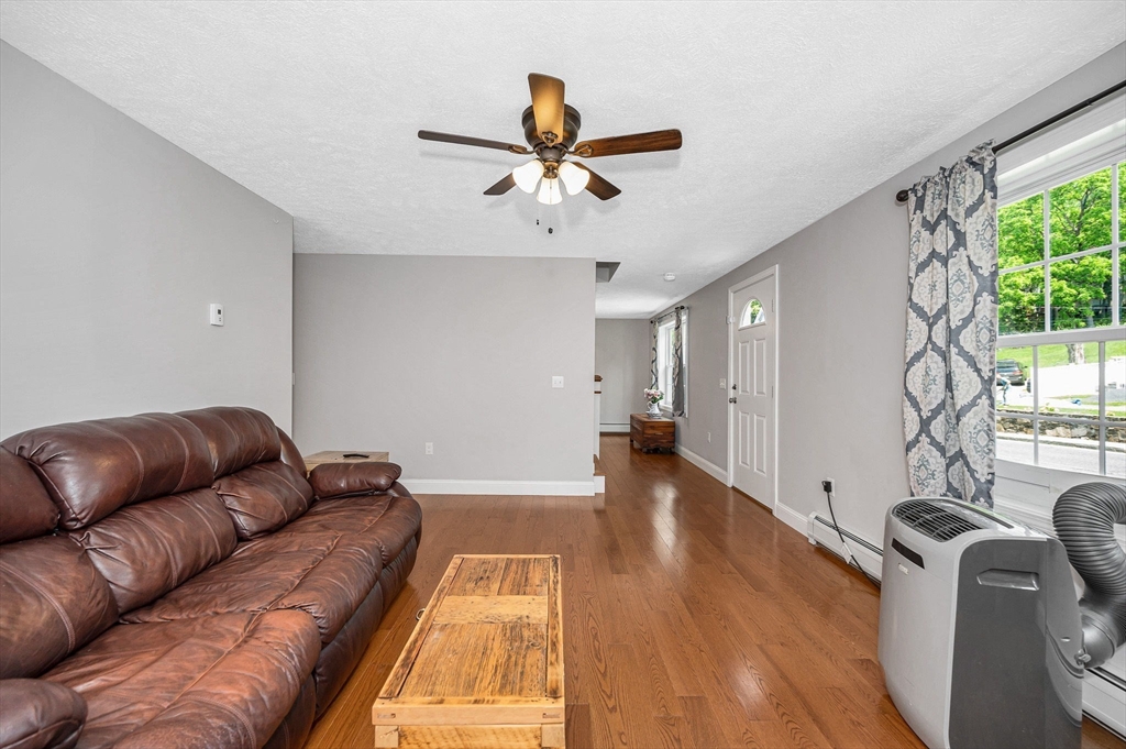 43 West Main Street Orange, MA 01364 - Photo 12 of 32 a living room with furniture and a ceiling fan