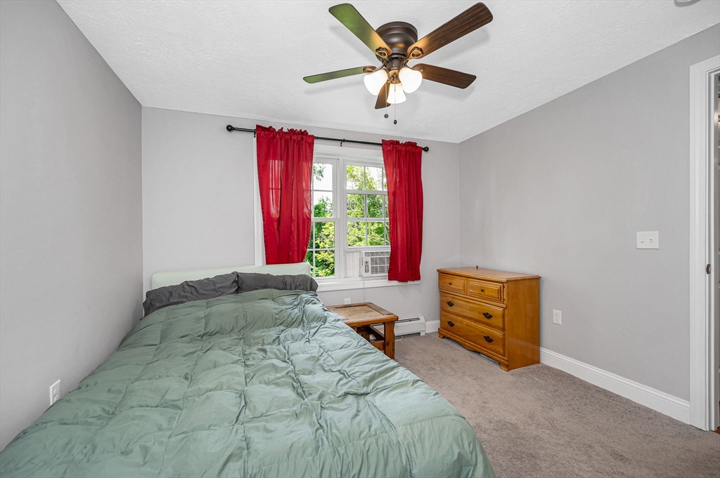 43 West Main Street Orange, MA 01364 - Photo 15 of 32 a bedroom with a bed and a chandelier