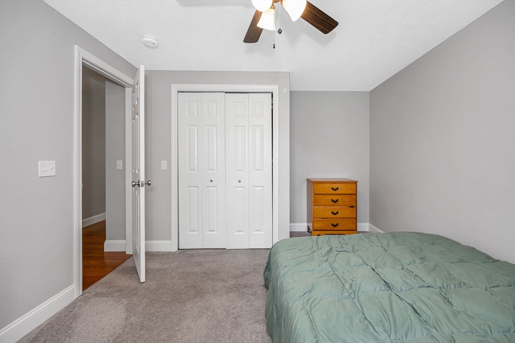 43 West Main Street Orange, MA 01364 - Photo 16 of 32 a bedroom with a bed and a ceiling fan