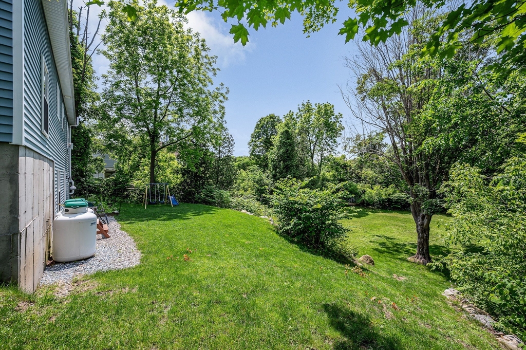 43 West Main Street Orange, MA 01364 - Photo 25 of 32 a view of a backyard with potted plants and large trees