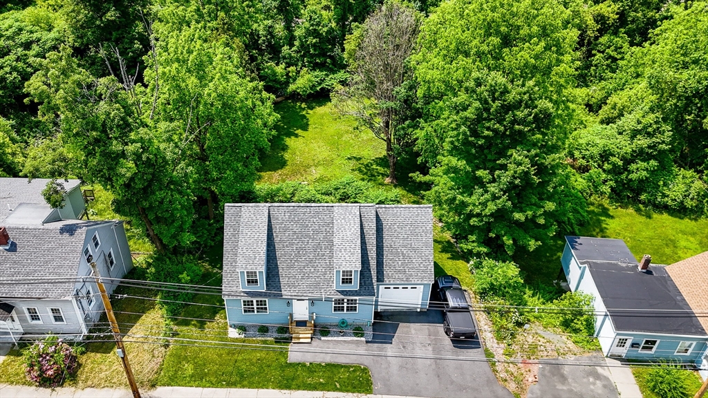 43 West Main Street Orange, MA 01364 - Photo 30 of 32 an aerial view of a house with garden space and a yard