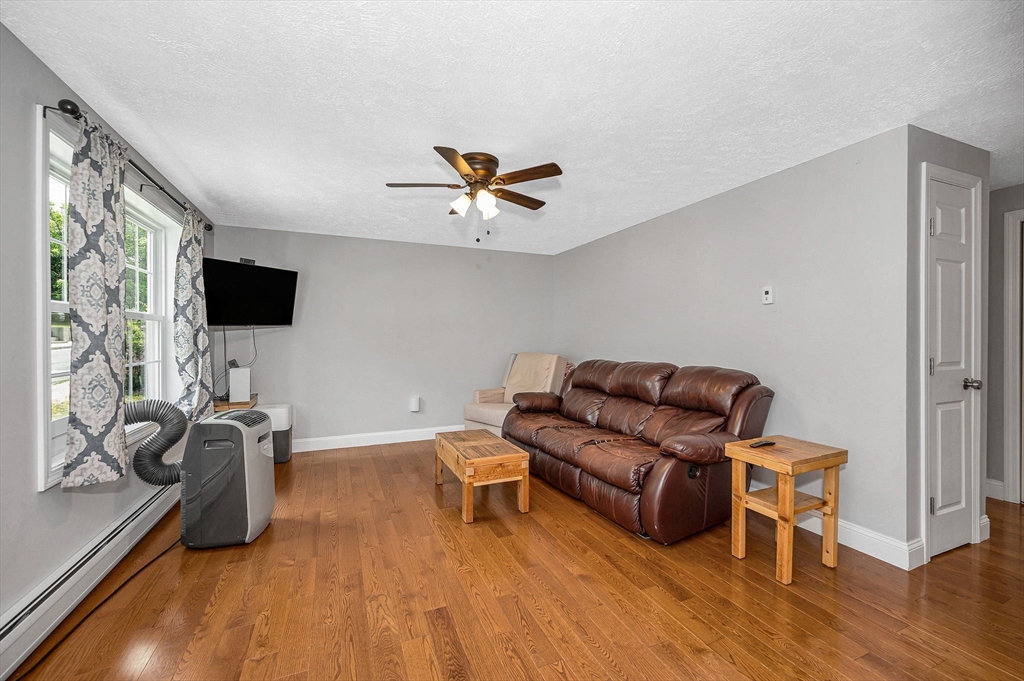 43 West Main Street Orange, MA 01364 - Photo 10 of 32 a living room with furniture and a flat screen tv