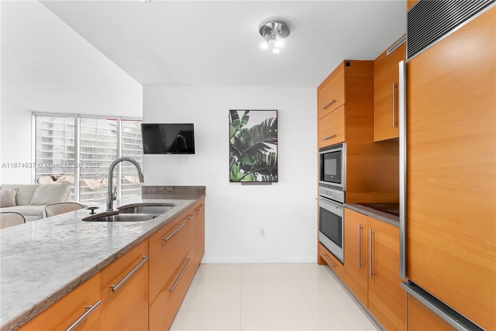 465 Brickell Avenue, Unit 2702 Miami, FL 33131 - Photo 11 of 22 a kitchen with stainless steel appliances granite countertop a sink and a refrigerator