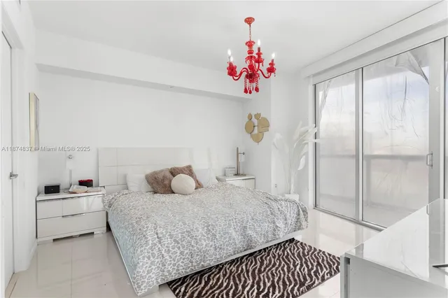 a bedroom with a bed and a window with painted walls