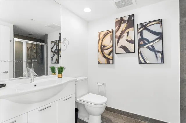 a bathroom with a sink toilet and shower