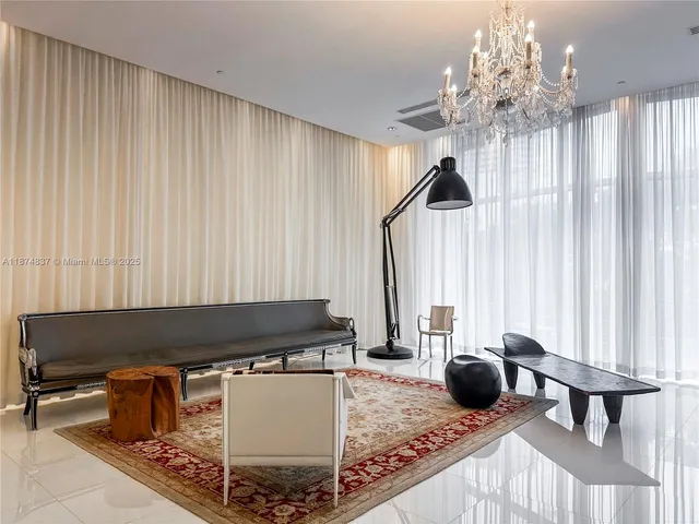 a living room with furniture and a chandelier