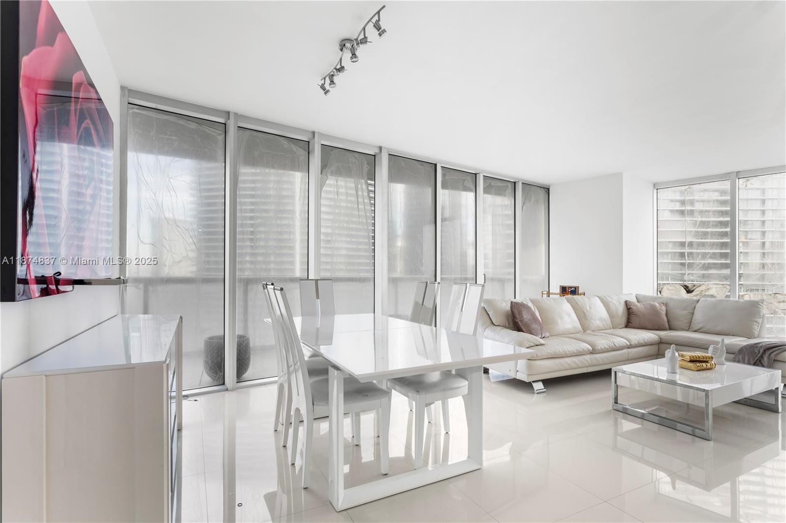 465 Brickell Avenue, Unit 2702 Miami, FL 33131 - Photo 2 of 22 a living room with furniture and a large window