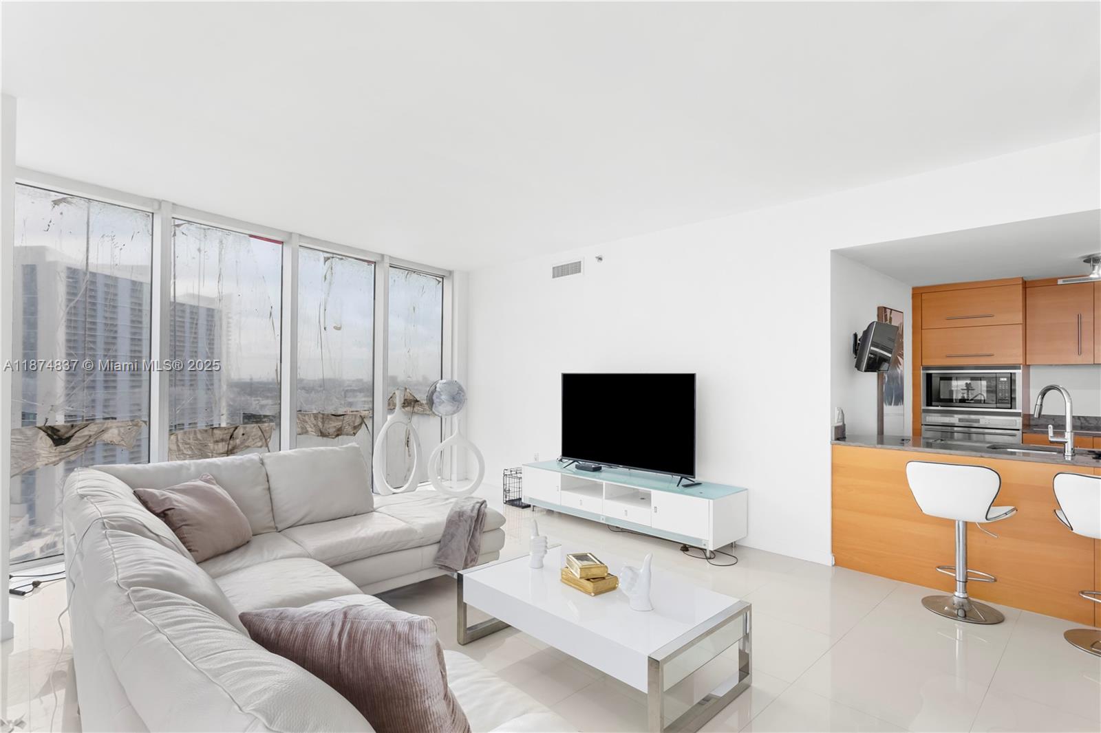 465 Brickell Avenue, Unit 2702 Miami, FL 33131 - Photo 5 of 22 a living room with furniture and a flat screen tv