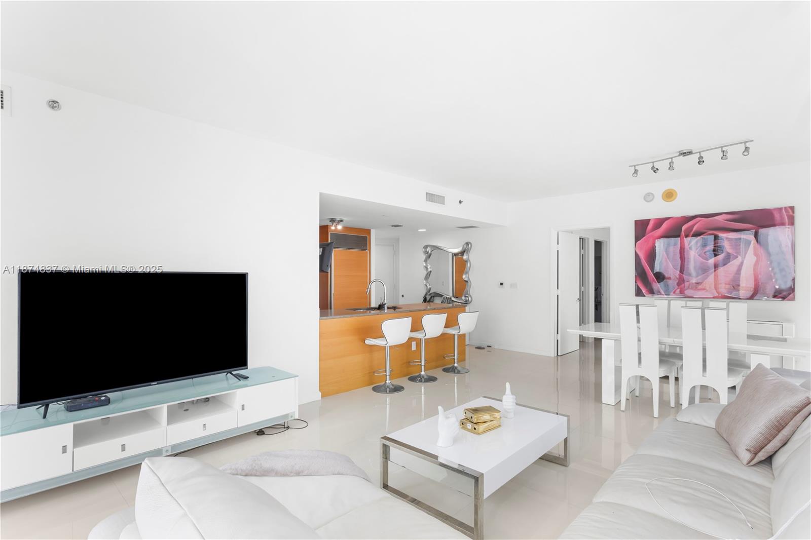465 Brickell Avenue, Unit 2702 Miami, FL 33131 - Photo 6 of 22 a living room with furniture and a flat screen tv