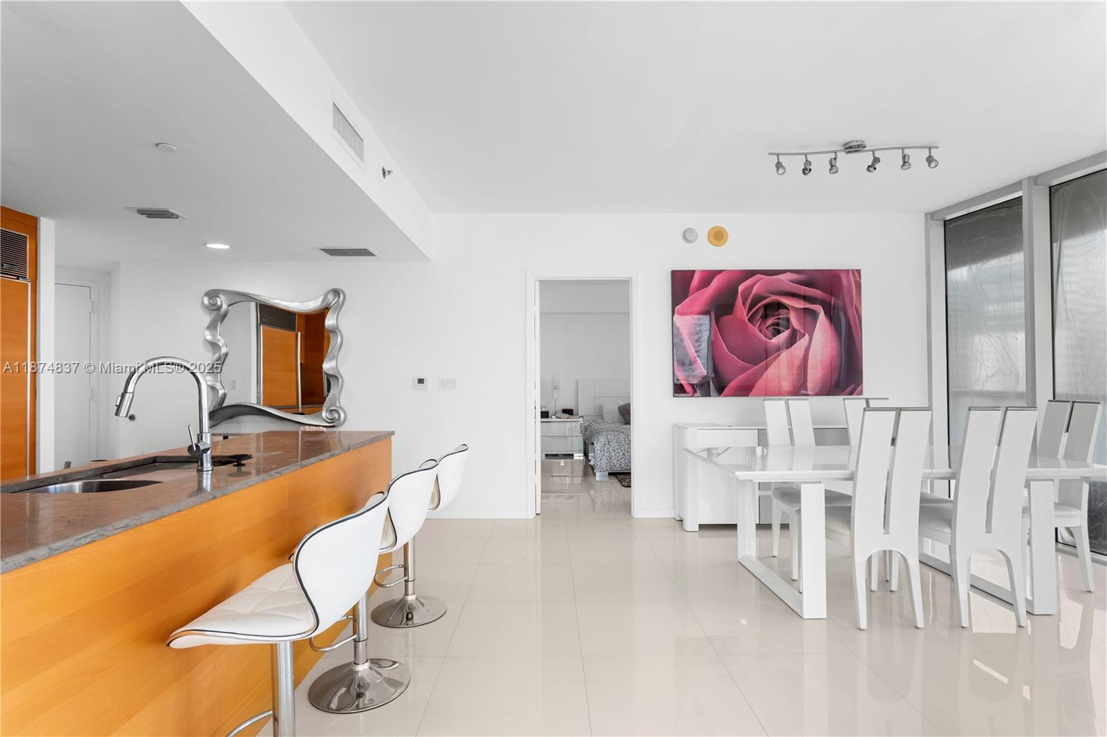 465 Brickell Avenue, Unit 2702 Miami, FL 33131 - Photo 9 of 22 a bed room with a bed and a chair