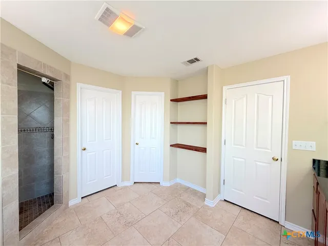 a view of an empty room with closet area