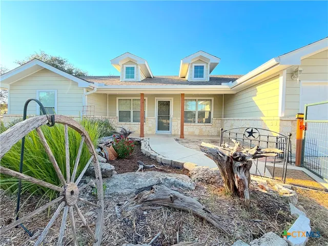 a view of a house with backyard and sitting area