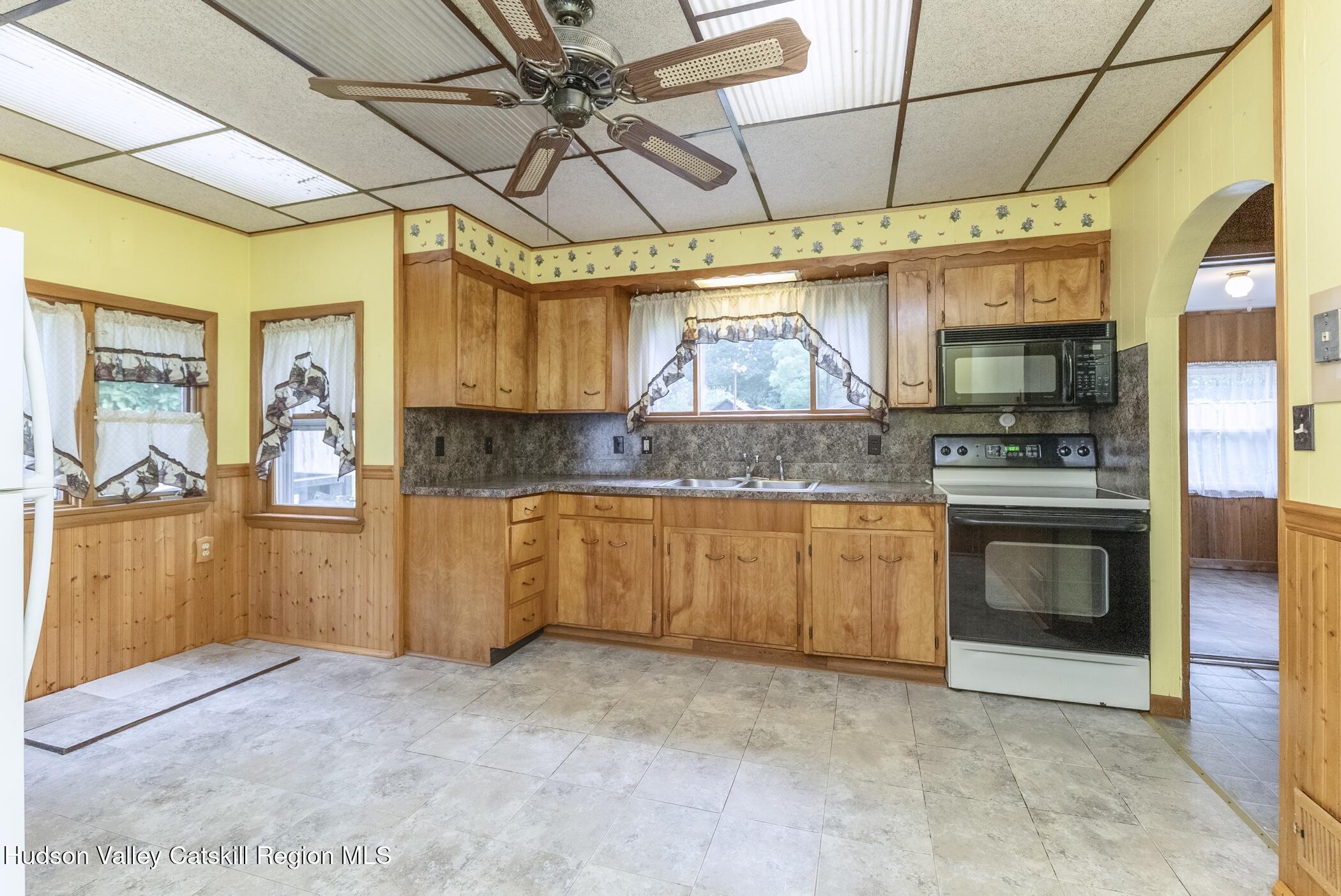 23 Maple Street Rifton, NY 12471 - Photo 15 of 43 a kitchen with granite countertop a stove a sink and a microwave