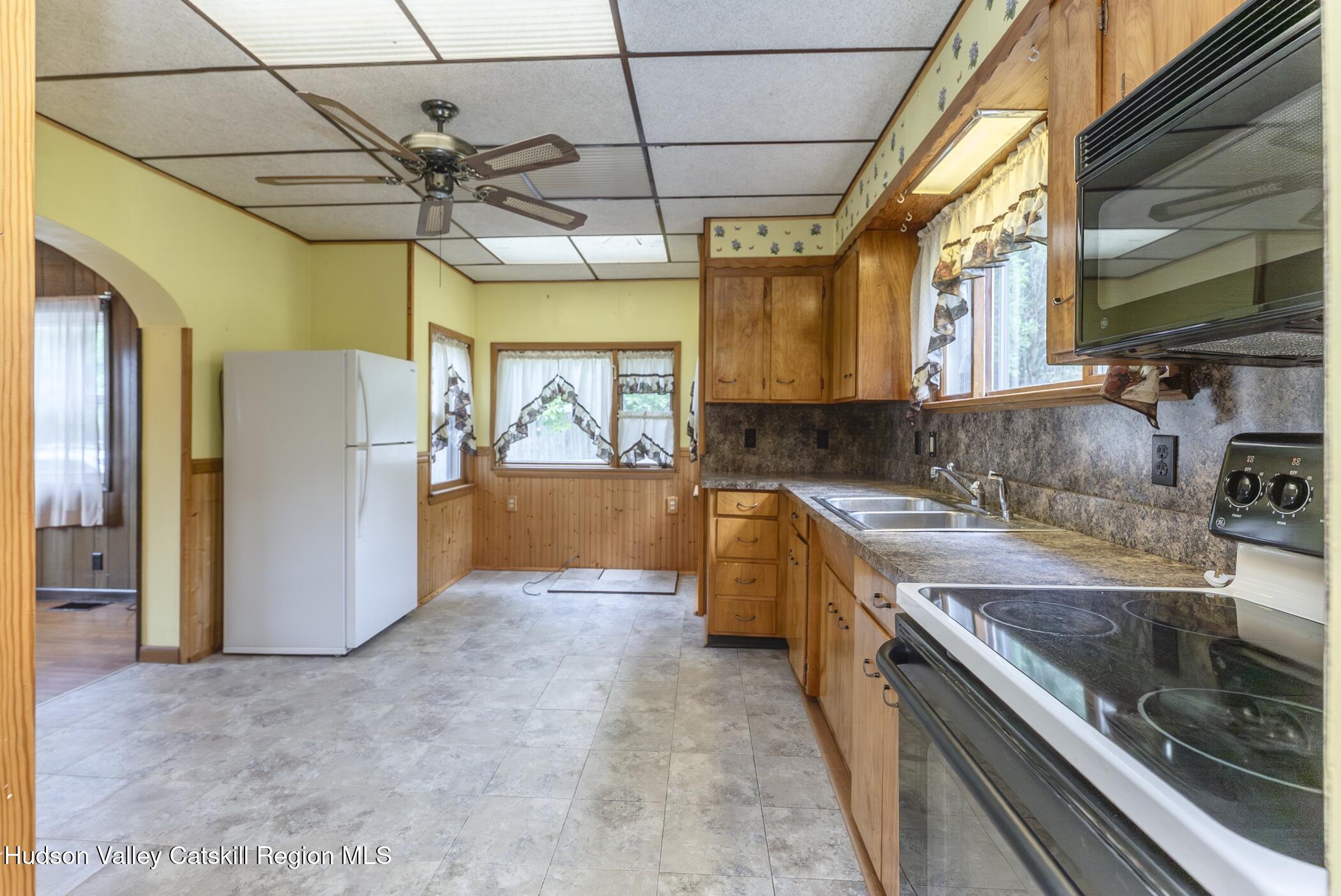 23 Maple Street Rifton, NY 12471 - Photo 17 of 43 a kitchen with stainless steel appliances granite countertop a sink a counter space cabinets and a window