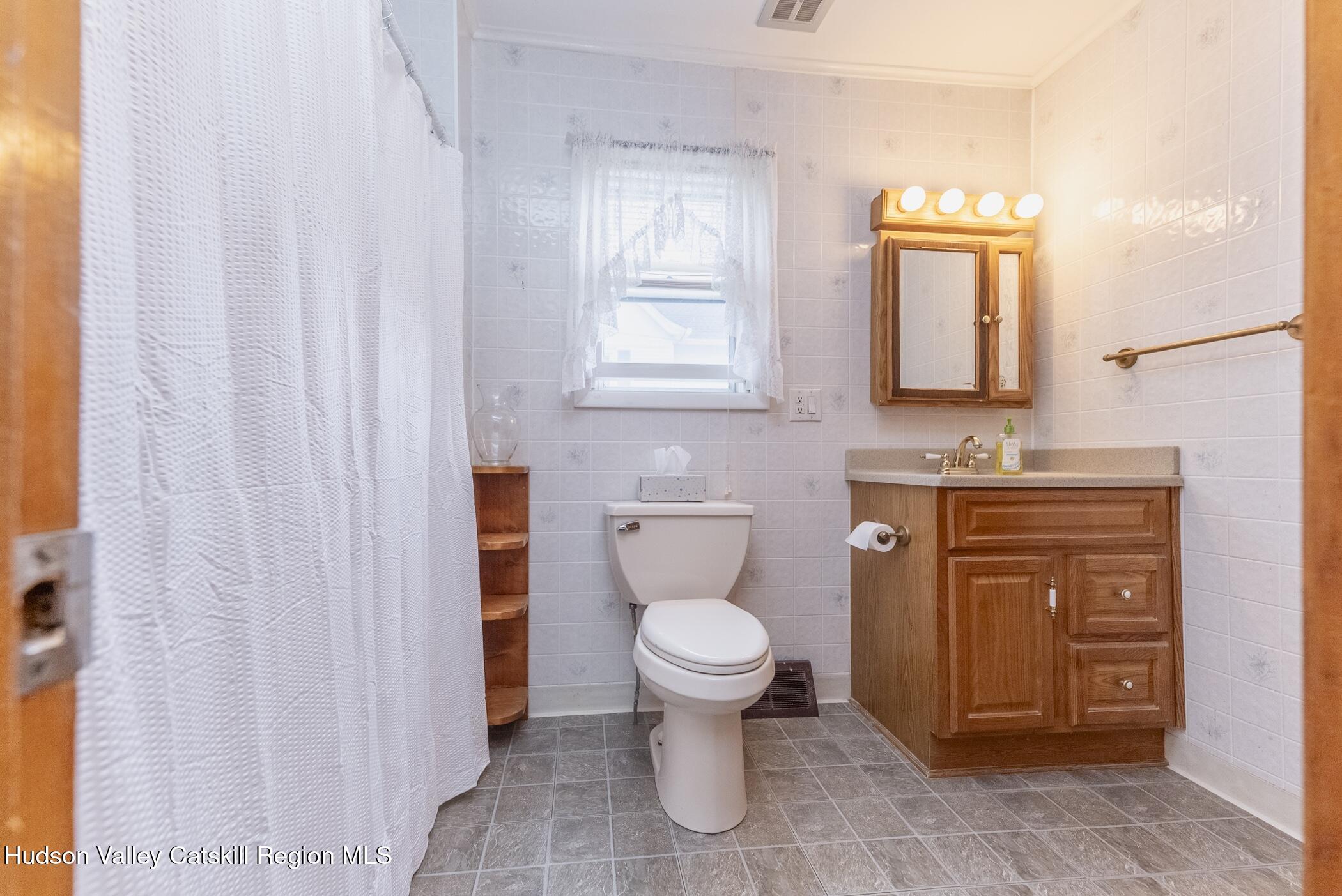 23 Maple Street Rifton, NY 12471 - Photo 21 of 43 a bathroom with a toilet sink and mirror