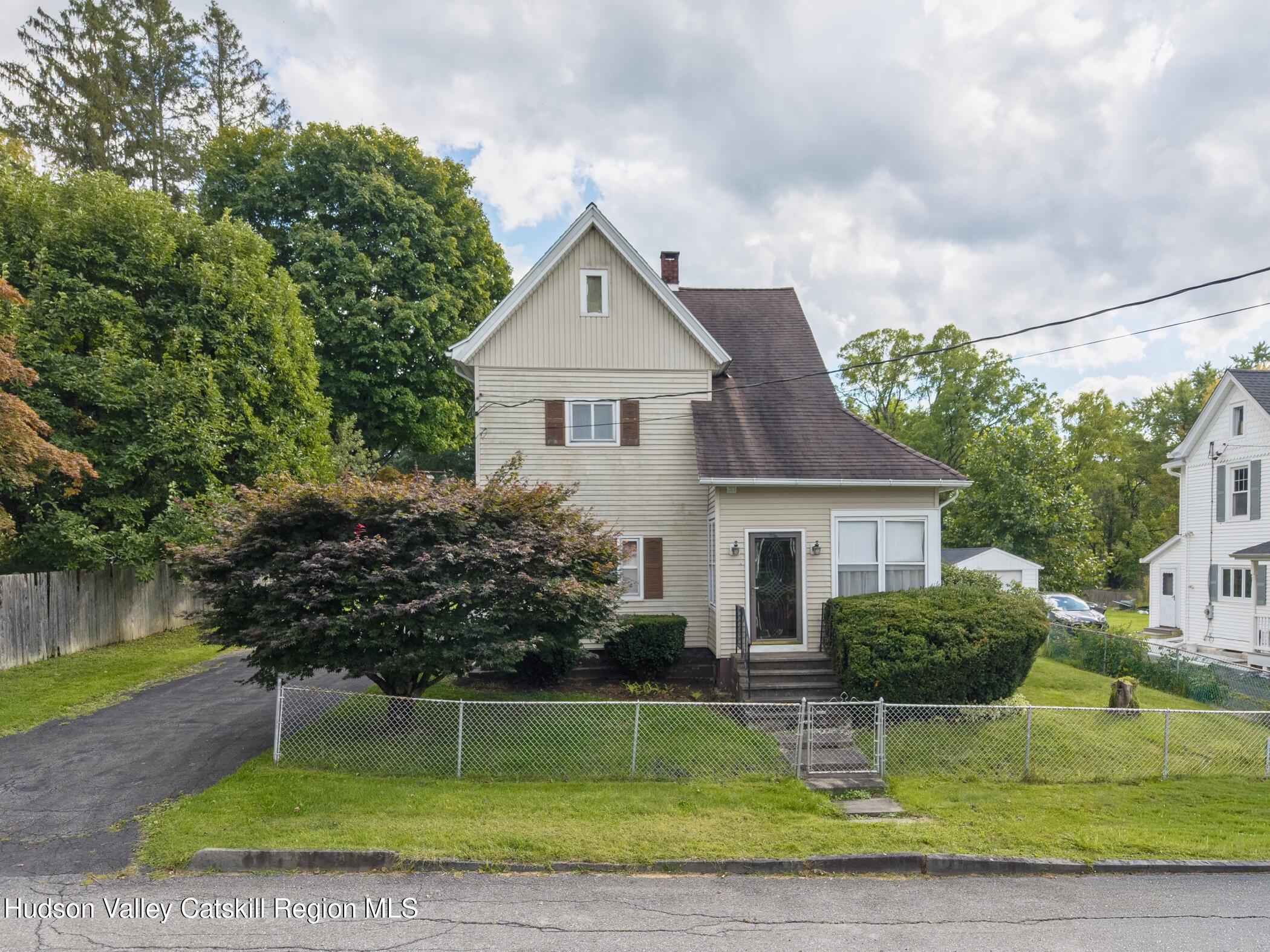 23 Maple Street Rifton, NY 12471 - Photo 4 of 43 a front view of a house with a yard and potted plants