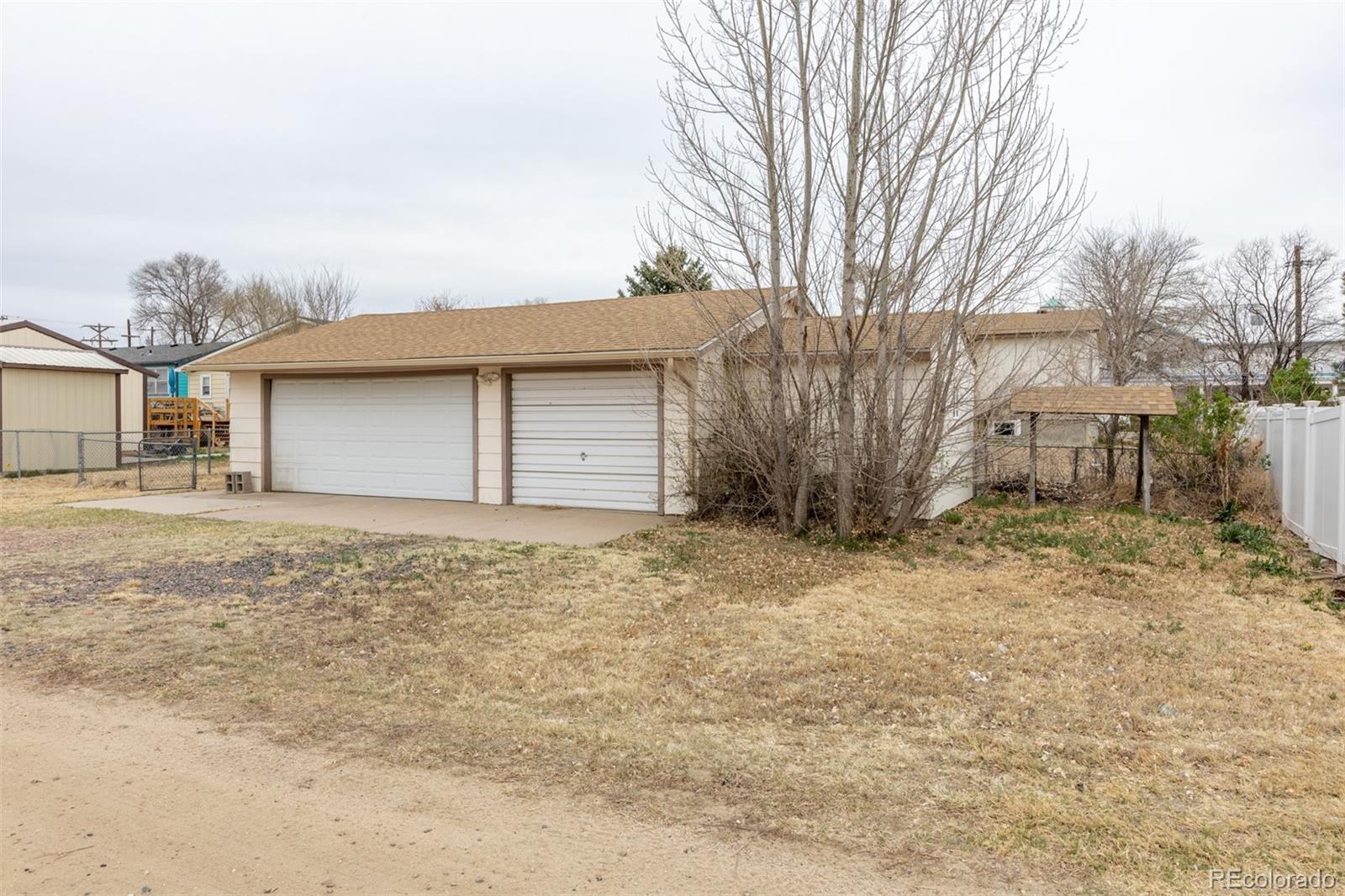 114 6th Street Hugo, CO 80821 - Photo 11 of 50 a house with trees in front of it