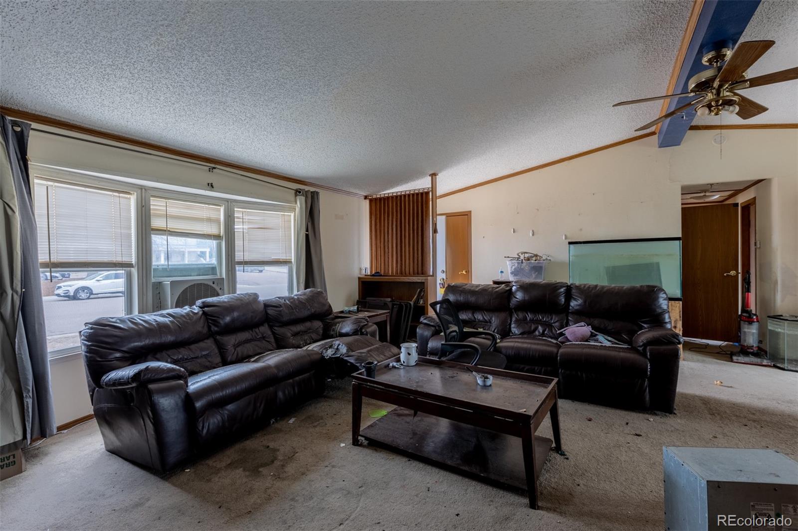 114 6th Street Hugo, CO 80821 - Photo 16 of 50 a living room with furniture and a flat screen tv