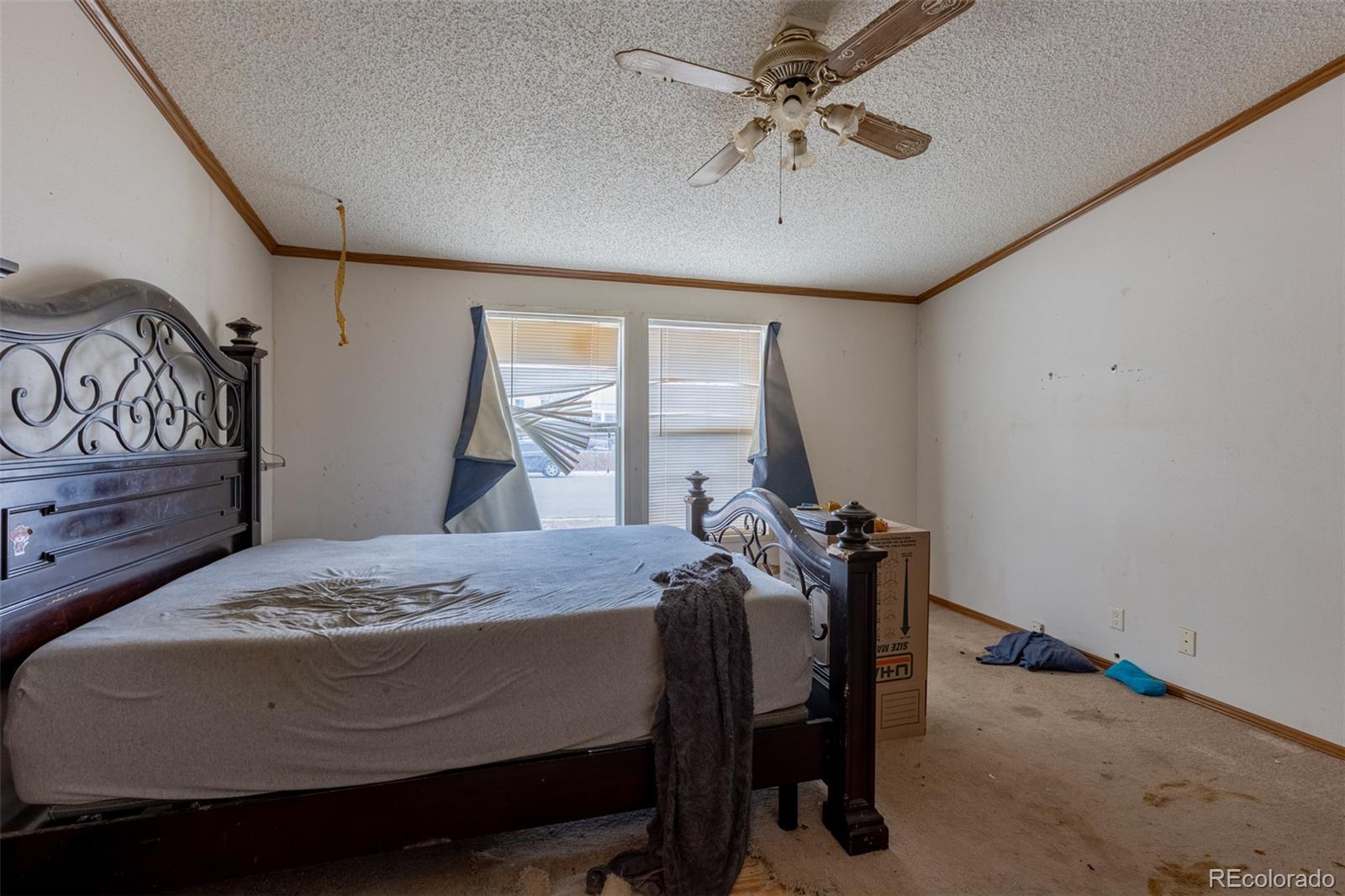 114 6th Street Hugo, CO 80821 - Photo 20 of 50 a bedroom with a bed and a dresser