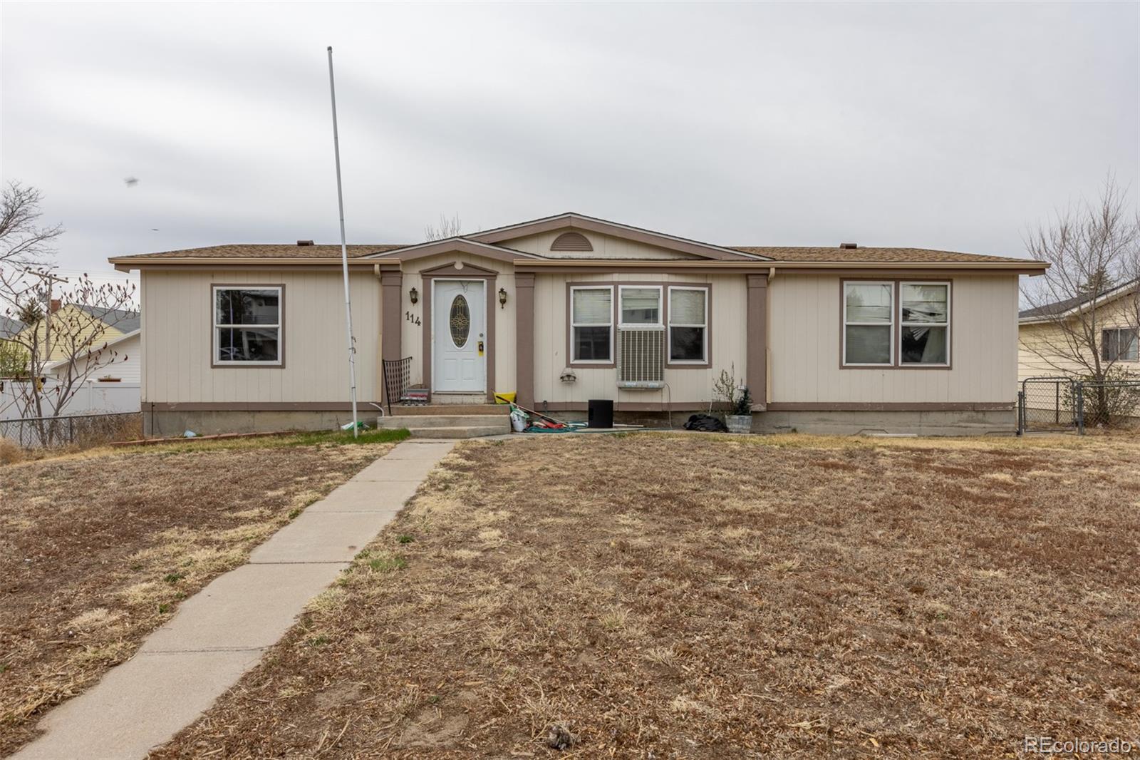 114 6th Street Hugo, CO 80821 - Photo 2 of 50 a front view of a house with a yard