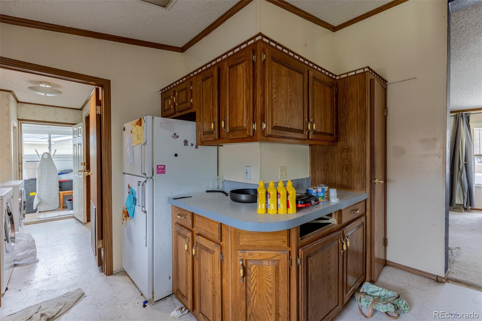 114 6th Street Hugo, CO 80821 - Photo 34 of 50 a kitchen with stainless steel appliances granite countertop a refrigerator a stove and a sink