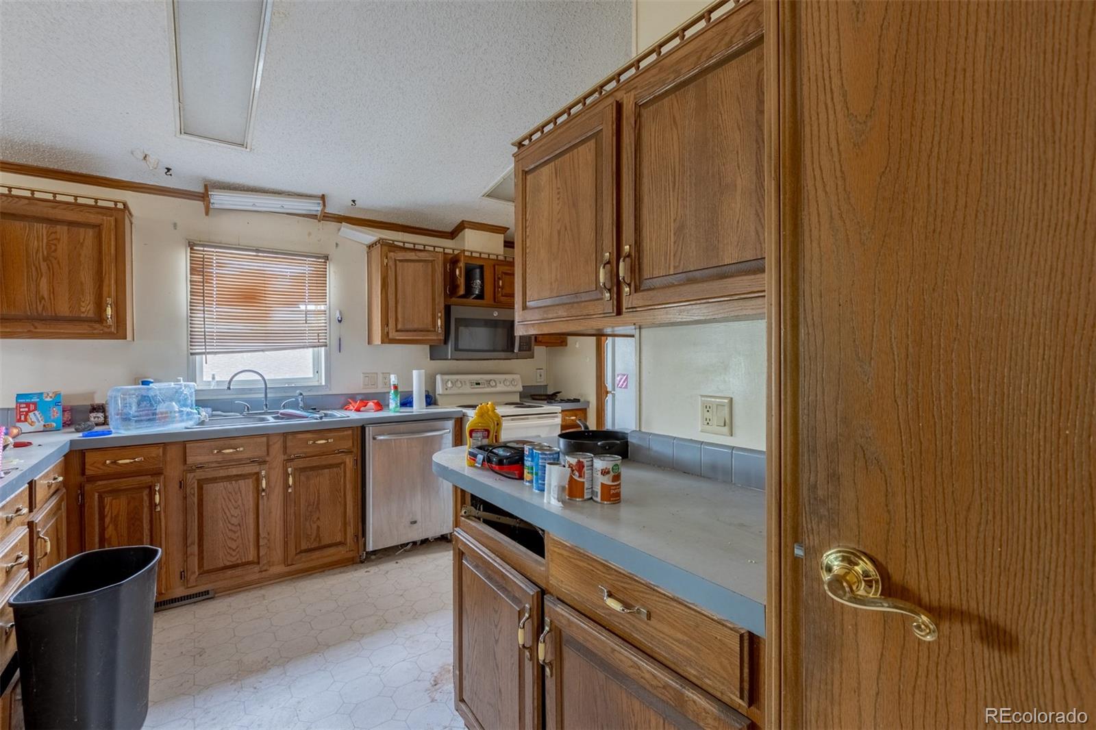 114 6th Street Hugo, CO 80821 - Photo 35 of 50 a kitchen with stainless steel appliances granite countertop a sink stove and cabinets