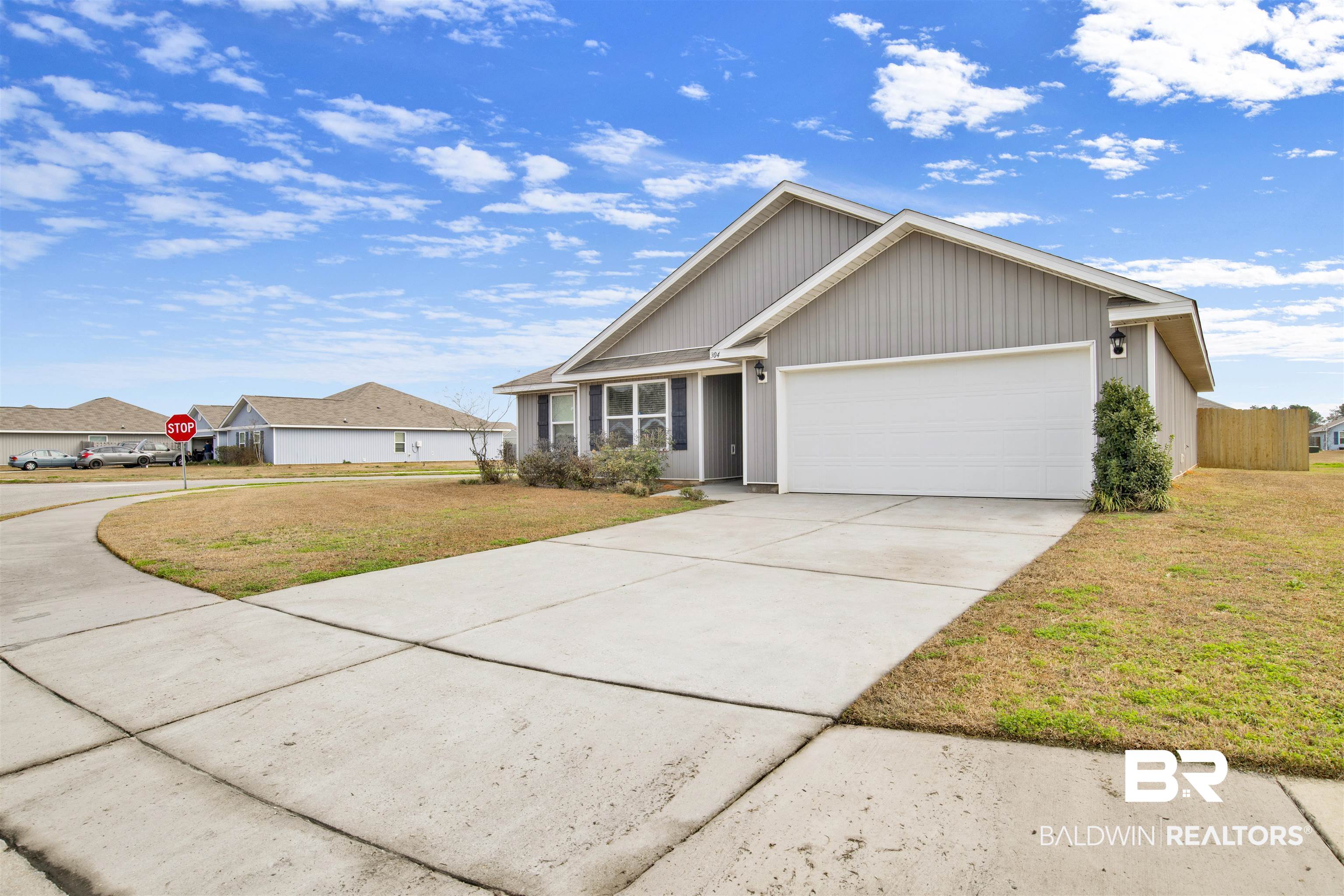 304 Hartenstein Road Foley, AL 36535 - Photo 2 of 28 View of front of property featuring a garage and a front lawn