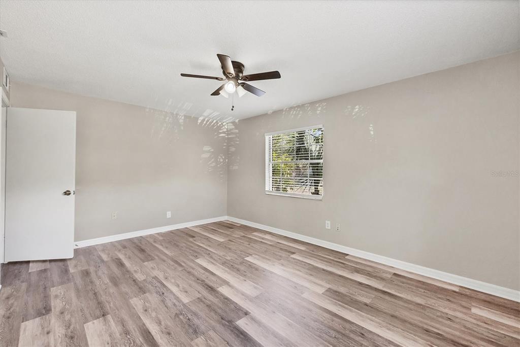 2403 Aspinwall Street Sarasota, FL 34237 - Photo 14 of 26 a view of empty room with wooden floor and fan