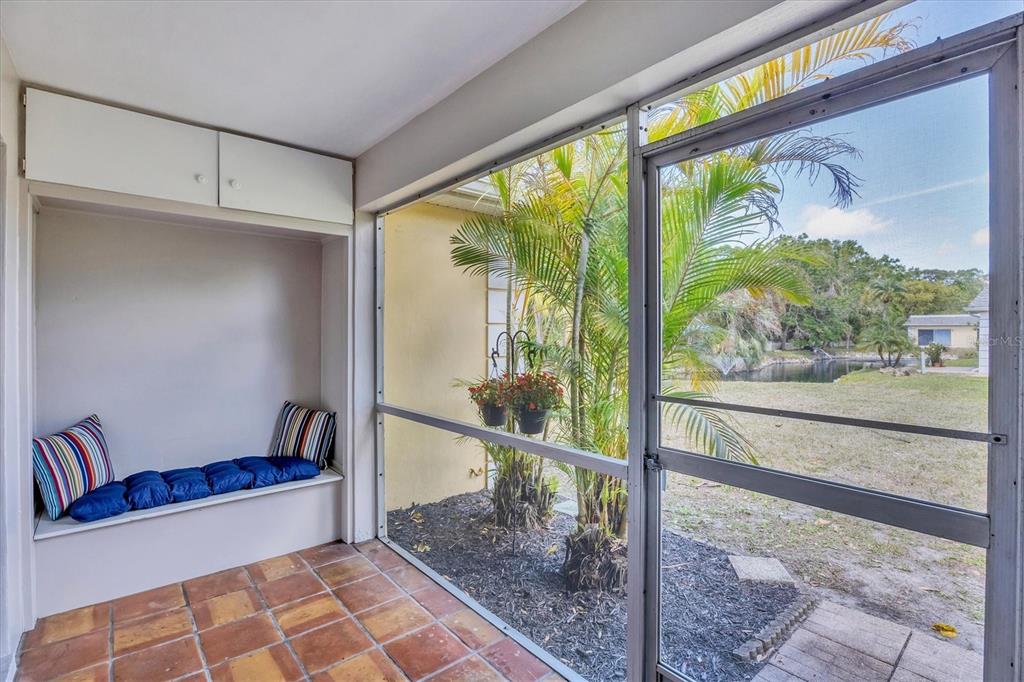 2403 Aspinwall Street Sarasota, FL 34237 - Photo 2 of 26 a living room with a floor to ceiling window and a glass door