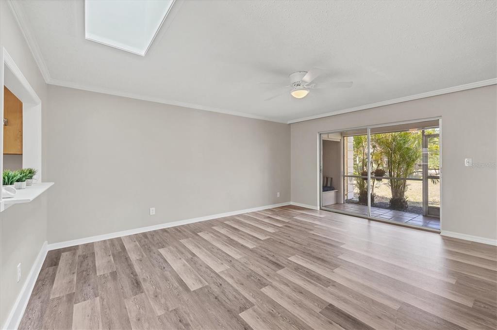 2403 Aspinwall Street Sarasota, FL 34237 - Photo 5 of 26 a view of an empty room with wooden floor and a window