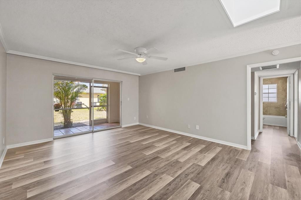 2403 Aspinwall Street Sarasota, FL 34237 - Photo 6 of 26 a view of an empty room with wooden floor and a window