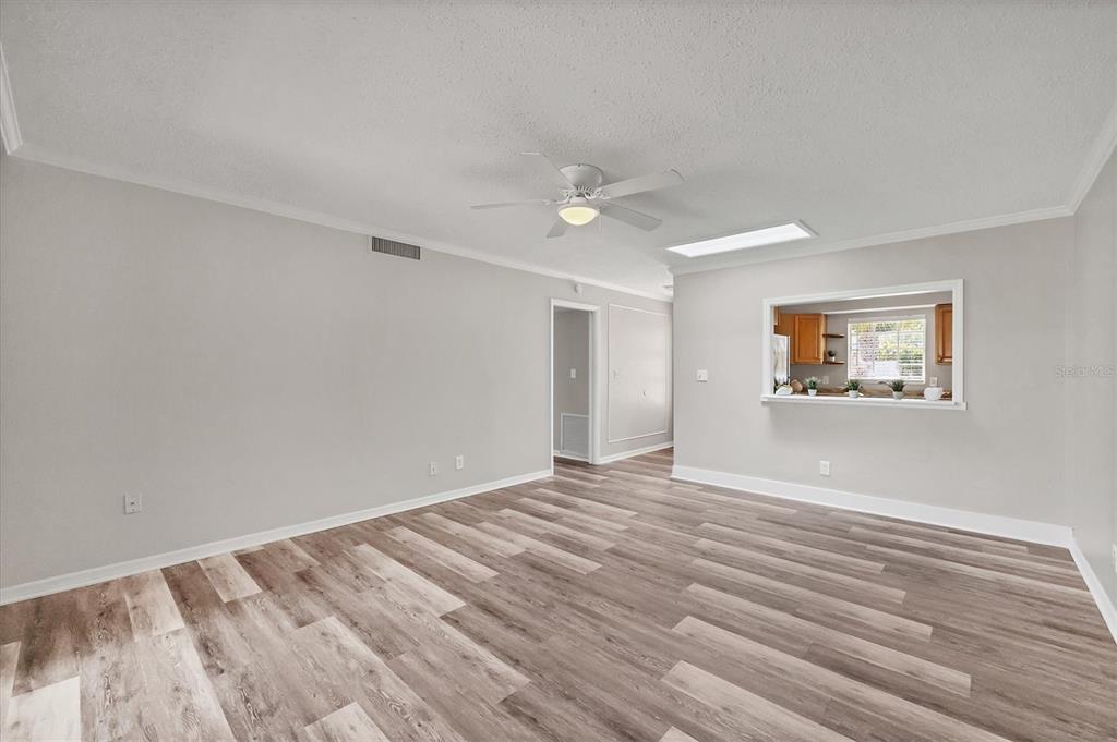 2403 Aspinwall Street Sarasota, FL 34237 - Photo 7 of 26 a view of empty room with wooden floor and fan