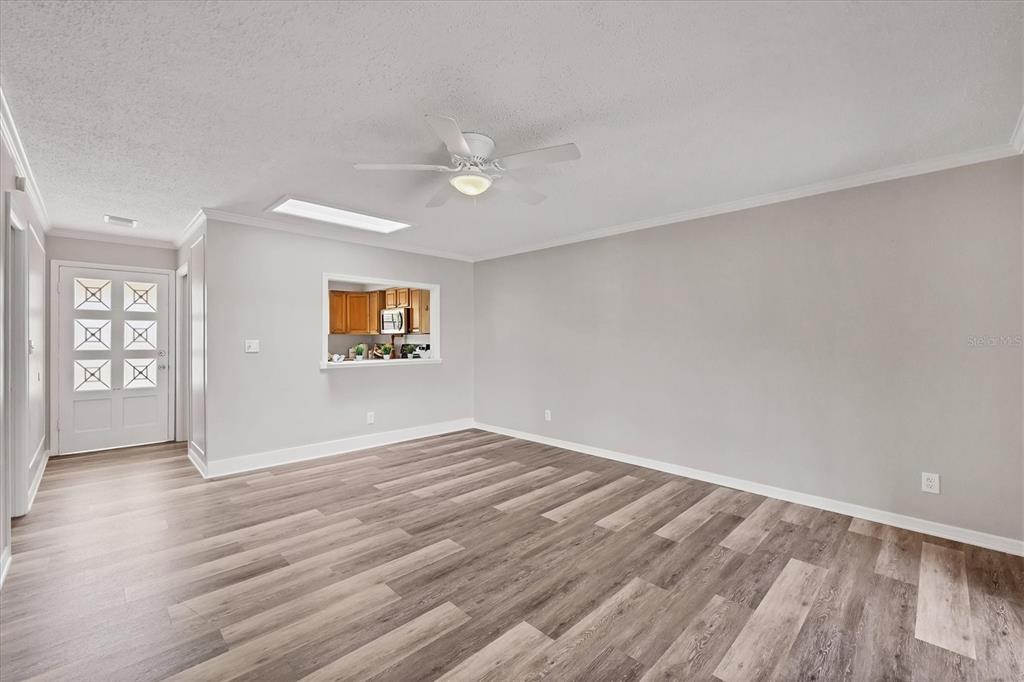 2403 Aspinwall Street Sarasota, FL 34237 - Photo 8 of 26 an empty room with wooden floor and windows