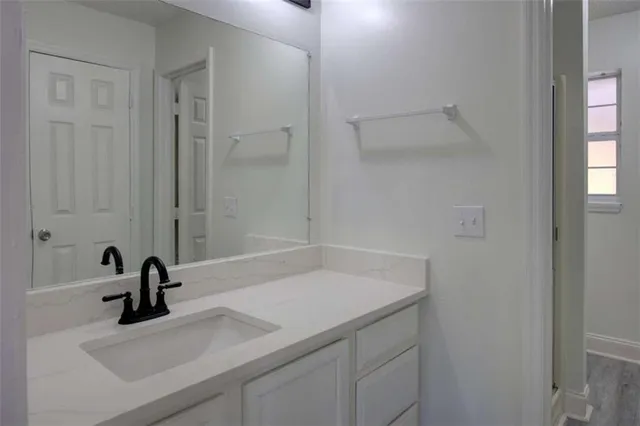 a bathroom with a sink and a mirror