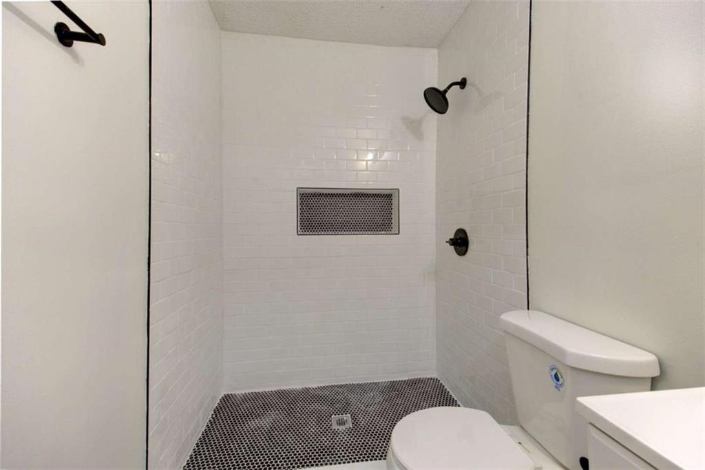 390 Rocky Point Road Covington, GA 30014 - Photo 16 of 19 a bathroom with a toilet and a shower