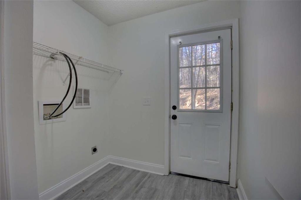 390 Rocky Point Road Covington, GA 30014 - Photo 18 of 19 an empty room with wooden floor and windows
