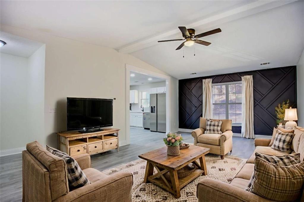 390 Rocky Point Road Covington, GA 30014 - Photo 3 of 19 a living room with furniture and a flat screen tv