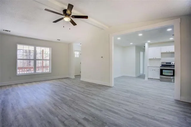 wooden floor in an empty room with a window