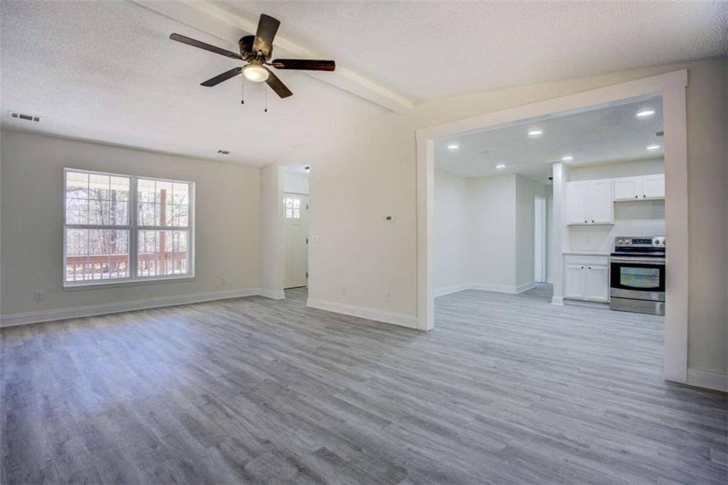 390 Rocky Point Road Covington, GA 30014 - Photo 4 of 19 wooden floor in an empty room with a window