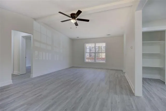 wooden floor in an empty room with a window