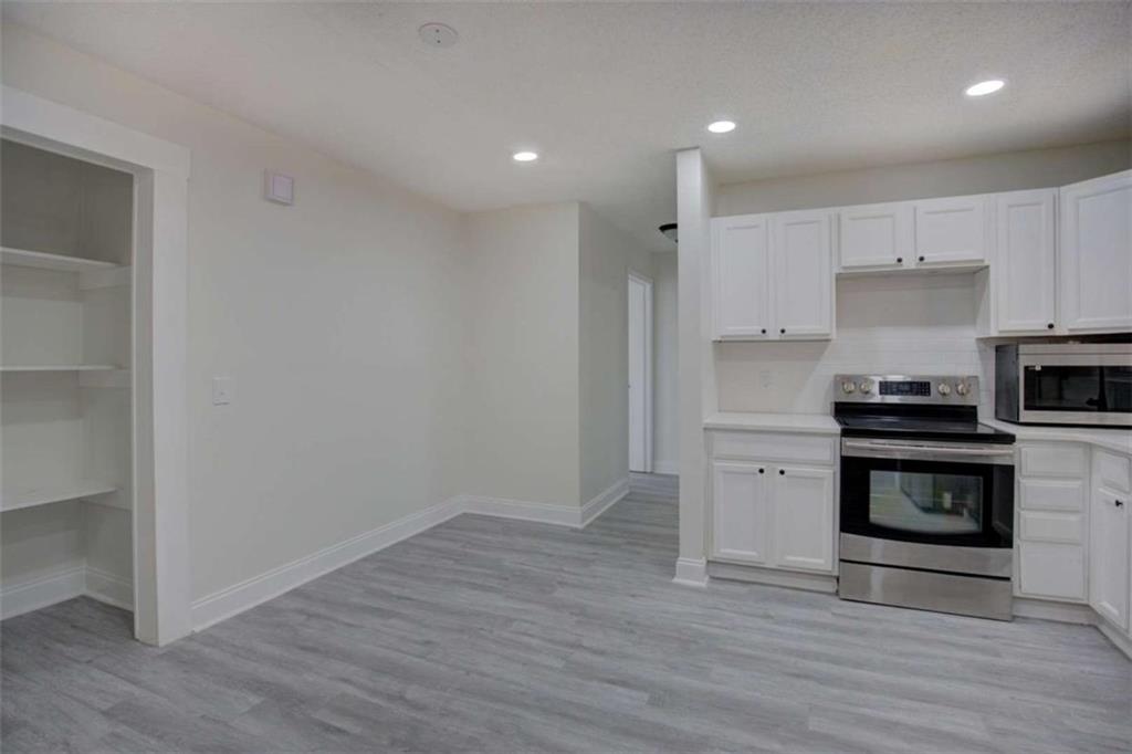 390 Rocky Point Road Covington, GA 30014 - Photo 7 of 19 a kitchen with a refrigerator and a stove top oven