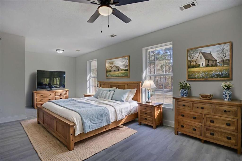 390 Rocky Point Road Covington, GA 30014 - Photo 10 of 19 a bedroom with a bed and a tv on the dresser