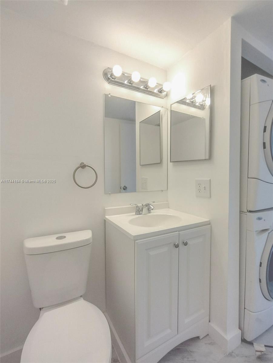 4174 Inverrary Drive, Unit 706 Lauderhill, FL 33319 - Photo 11 of 59 a bathroom with a toilet sink and mirror