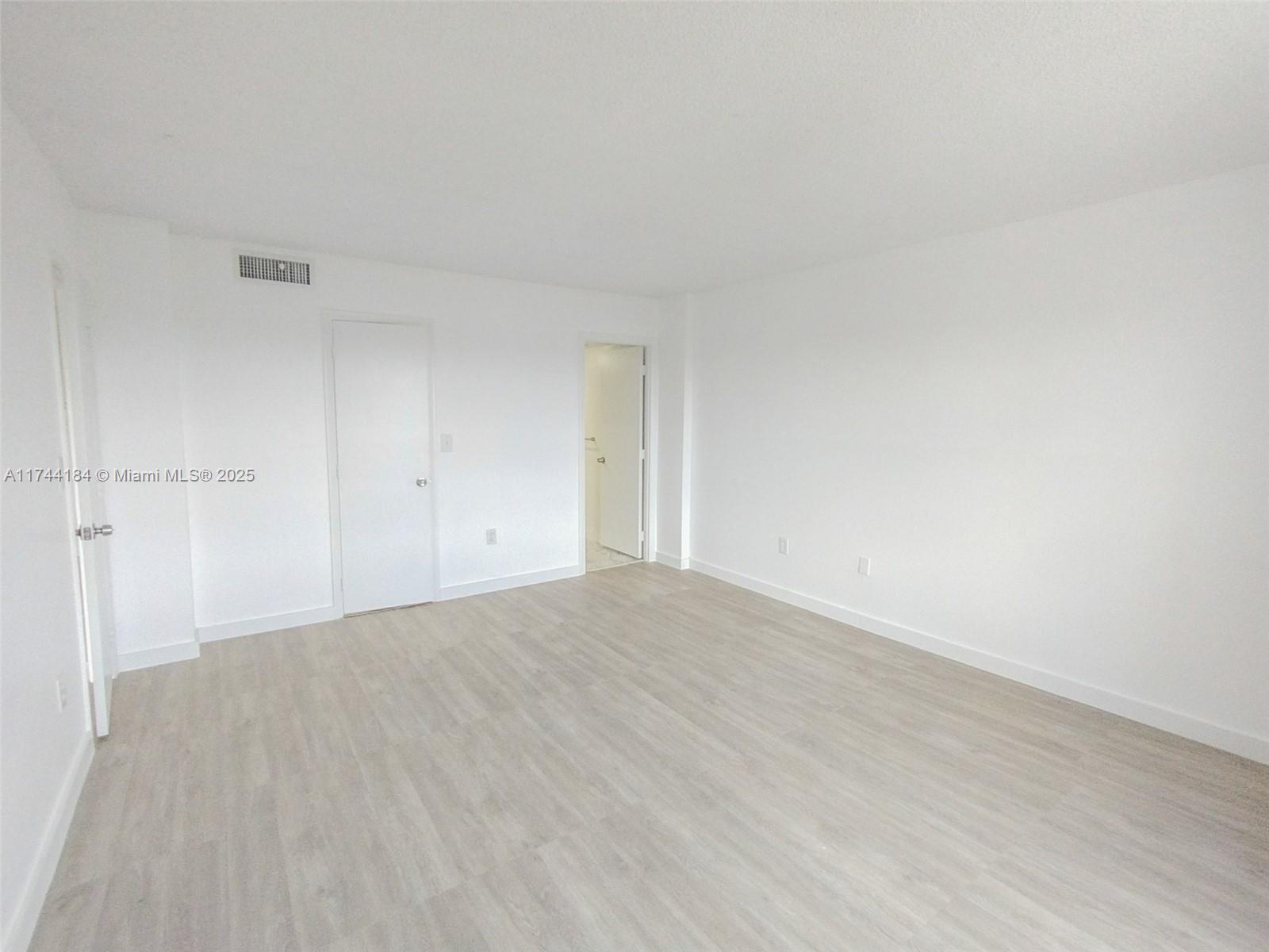 4174 Inverrary Drive, Unit 706 Lauderhill, FL 33319 - Photo 20 of 59 a view of an empty room and wooden floor