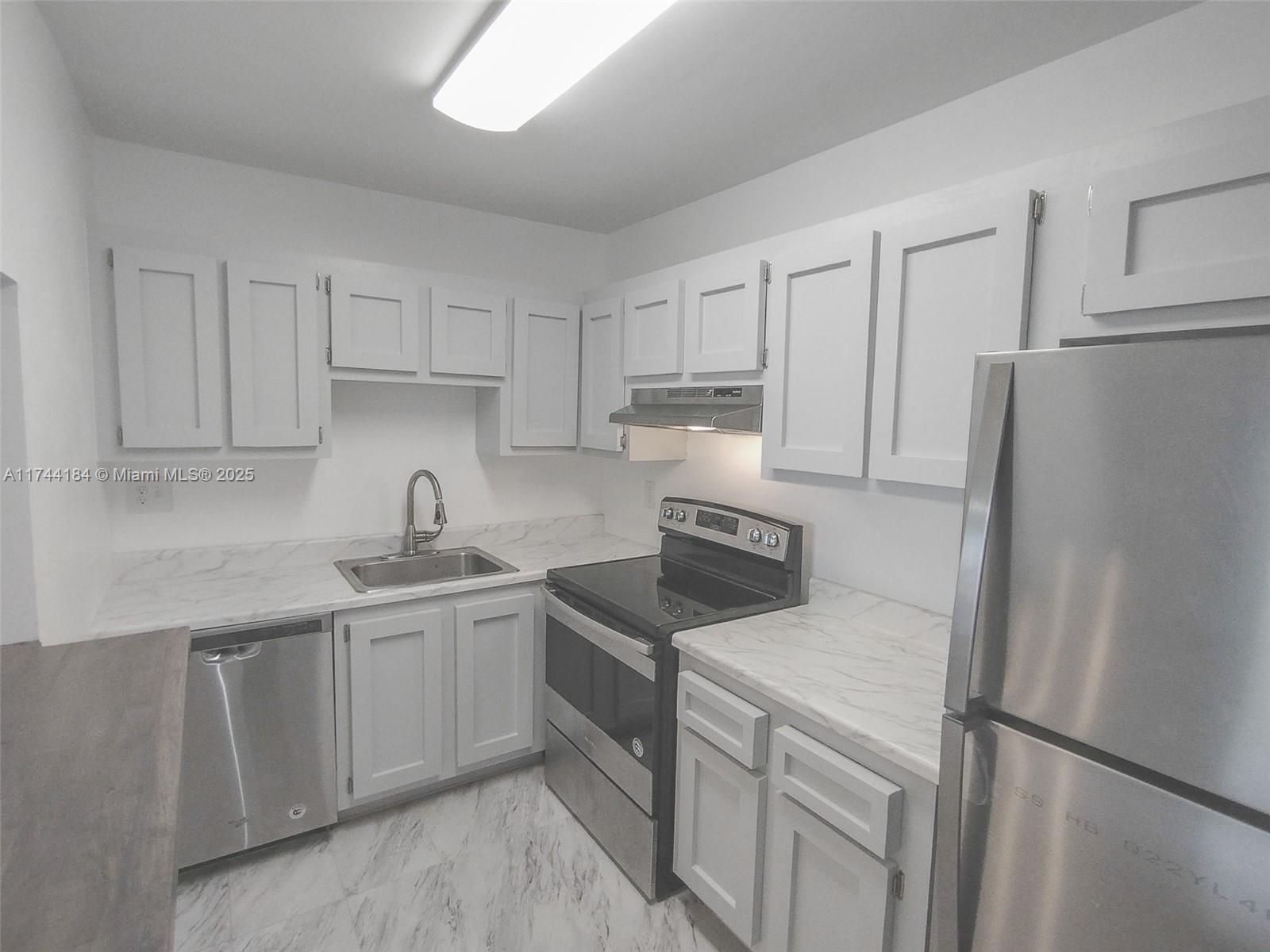 4174 Inverrary Drive, Unit 706 Lauderhill, FL 33319 - Photo 2 of 59 a kitchen with stainless steel appliances granite countertop white refrigerator stove top oven and sink